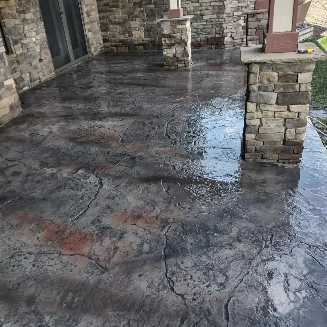 Flagstone stamped concrete patio floor with irregular stone shapes in mixed earth tones.